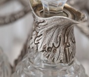 An English Georgian sterling silver nine piece cruet set with Rococo&nbsp;floral border standing on acanthus and shell feet. The cruet bottles of&nbsp;reeded crystal form with conforming acanthus silver mounts. Made by&nbsp;Joseph Angell of London, 26cm high, 27cm wide, - 5