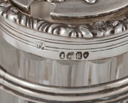 An English Georgian sterling silver nine piece cruet set with Rococo&nbsp;floral border standing on acanthus and shell feet. The cruet bottles of&nbsp;reeded crystal form with conforming acanthus silver mounts. Made by&nbsp;Joseph Angell of London, 26cm high, 27cm wide, - 6