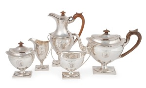 An antique English sterling silver bachelor's five piece tea service of classical form with applied oval depiction of Hope. The service comprises of a tea pot, hot water pot, sugar bowl, milk jug and tea caddy, with fruit wood handles and finials. Made by