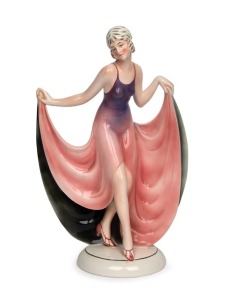 A German Art Deco&nbsp;porcelain figurine of a dancing girl with purple and pink dress by Katzhutte,&nbsp;20th century, ​​​​​​​factory mark to the base, 32cm high
