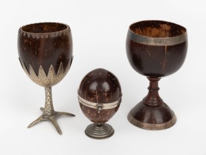 An antique coconut goblet with silver plated bird claw base, together with a Georgian coconut goblet with turned timber stem, and a coconut casket with later silver plated base, (3 items), the largest 18cm high