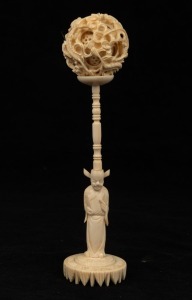 A vintage Chinese carved ivory puzzle ball with figural stand, mid 20th century, ​​​​​​​20cm high
