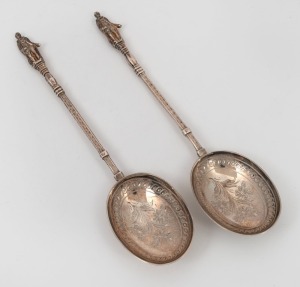 A fine quality pair of antique sterling silver apostle top serving spoons with engraved decoration, made in Sheffield by John Edward Bingham, Walker & Hall, circa 1876, 22cm long, 140 grams.