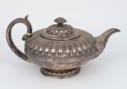 An antique English sterling silver teapot with lotus flower finial and acanthus decorated spout, made in London, circa 1823, 14cm high, 26cm wide, 684 grams - 2