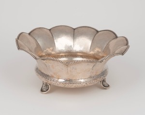 An antique&nbsp;German planished silver table bowl of scalloped form with beaded edge, stamped&nbsp;"830",. 9cm high, 22cm diameter, 374 grams
