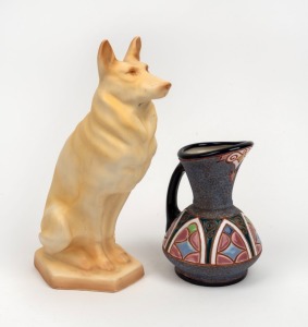 A Bohemian Art Deco Amphora jug attributed to Riessner, Stellmacher & Kessel with mottled glaze and Gothic decoration, factory mark base. Together with a porcelain figurine of a German Shepherd made by Ditmar-Urbach, Czechoslovakia, 20th century, (2 items