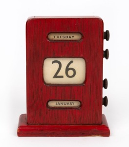 A vintage perpetual calendar in timber case with brick red finish, early to mid 20th century, 14cm high