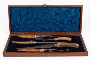 An antique English carving implement with deer antler handles, housed in a plush fitted walnut box, 19th/20th century, the box 46cm wide