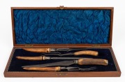 An antique English carving implement with deer antler handles, housed in a plush fitted walnut box, 19th/20th century, the box 46cm wide