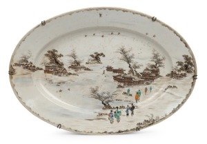 An antique Japanese porcelain oval serving platter with figures in village landscape, Meiji Period, 19th century, eight character seal mark to base, ​​​​​​​46cm wide