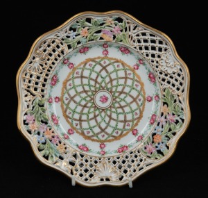 An antique Continental pierced porcelain cabinet plate with rose decoration and gilded highlights, 19th century, stamped "P. B. M.", 24cm wide