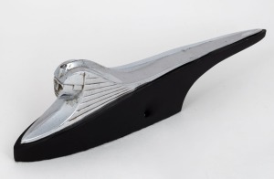 A vintage chrome metal car mascot of sphynx form, mounted on later ebonised wooden base, 33cm long overall