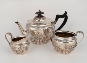 An antique three piece English sterling silver tea service, retailed by Mappin & Webb, made in London, circa 1891, the teapot 14cm high, 640 grams total including wooden handle