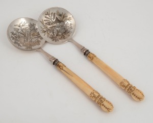 An attractive pair of antique English sterling silver serving spoons engraved with shells and seaweed motif, with finely carved marine ivory handles, made by James Dixon & Sons of Sheffield, circa 1879, 24.5cm long