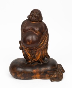 A Chinese bronze statue of a standing Buddha with remains of gilt finish, 20th century, 33cm high