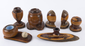 117 · A pair mulga wood bookends, urn, desk set match holder and two tobacco jars, early to mid 20th century, (7 items), ​the largest 17cm high