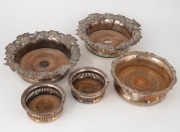 Five assorted antique silver plated and old Sheffield plate wine coasters, 18/19th century, the largest 19cm wide