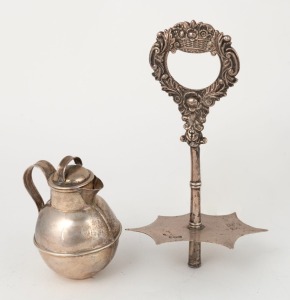An antique English sterling silver Jersey cream jug with Jersey retailer's stamp, made by W.G. Souther of Birmingham, circa 1898; together with a Georgian sterling silver cruet handle (as is), made in London, circa 1825, (2 items), the jug9cm high, 174 grams total