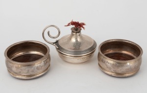 An antique sterling silver table cigar lighter, made in London, circa 1910; together with a pair of vintage sterling silver coasters with wooden inserts, by Elkington & Co. of Birmingham, circa 1935, (3 items), the lighter 7.5cm high, 222 grams total including wooden inserts