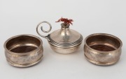 An antique sterling silver table cigar lighter, made in London, circa 1910; together with a pair of vintage sterling silver coasters with wooden inserts, by Elkington & Co. of Birmingham, circa 1935, (3 items), ​​​​​​​the lighter 7.5cm high, 222 grams tot