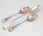An 18th century sterling silver basting spoon with engraved feathered edge decoration (marks rubbed); together with a pair of Georgian sterling silver tablespoons with fine engraved decoration by Richard Ferris of Exeter, circa 1796, (3 items), the bastin