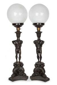 A pair of impressive cast bronze figural table lamps with spherical milk glass shades, rewired for Australian standards, 19th/20th century, 71cm high