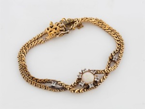 A vintage yellow gold plate twin strand bracelet, set with a polished solid opal surrounded with white diamonds, post WW2, 20th century, 15.4 grams