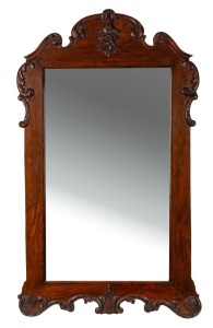 An antique English walnut veneered wall mirror in the Georgian style with applied floral and scroll decoration, circa 1910, 105cm high, 62cm wide
