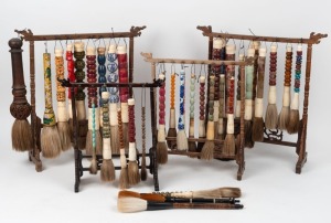 SCHOLAR'S BRUSHES: A collection of 38 examples of varying forms and ages, mostly 20th century, attractively displayed on four timber stands, the largest stand 48cm high