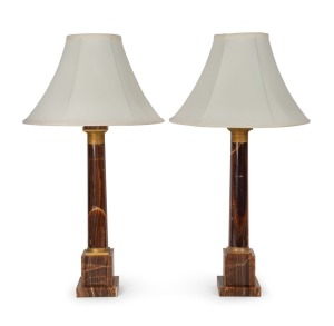 A fine pair of early 20th century table lamps in the French empire style, well figured brown onyx, with ormolu&nbsp;gilt capitals, height 75cm including shades. (2 items)