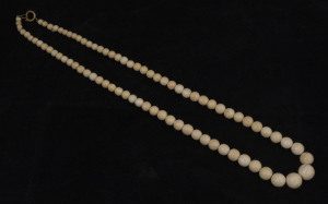 An antique ivory graduated bead necklace, 19th century, 66cm long