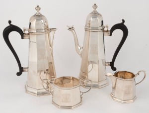 An antique English sterling silver tea set in the George I style, comprising of tea pot, hot water pot, two handled sugar bowl and milk jug, each piece engraved with owner's initials. Made in London, circa 1929 by Thomas Bradbury & Sons, (the milk jug mar