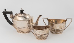 An antique English bachelor's tea set comprising of a tea pot, two handled sugar bowl and milk jug with gadrooned decoration, made by Walker & Hall of Sheffield, circa 1904, (3 items), the tea pot 13ch high, 506 grams total.