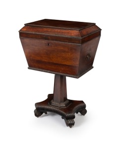An antique English William IV period sarcophagus form cellarette, handsomely veneered in rosewood with knurled moulding and brass carrying handles to the sides. The tapered pedestal terminating in a quadriform base with brass castors, circa 1840, 74cm high, 50cm wide, 34cm deep