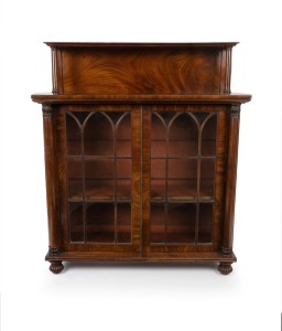 An antique English William IV flame mahogany chiffonier with Gothic astragal glassed doors, central brass door bead, flanked by full columns&nbsp;with acanthus carved capitals. Raised back with single shelf and matching column supports, circa 1845, 125cm high,