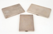 Three sterling silver cigarette cases, 20th century, the largest 14cm wide, 640 grams total