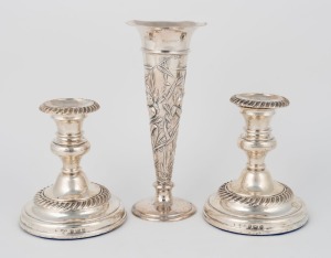 A pair of antique English sterling silver candlesticks with knopped stems and gadrooned decoration, marked M. & Co., Birmingham, circa 1903; together with an English sterling silver trumpet vase with Art Nouveau repouss&eacute; decoration made by William Comyns 