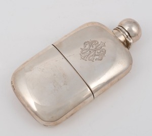 A handsome antique English sterling silver hip flask with engraved monogram, bayonet locking cap and fitted cup with gilt wash interior. Made by George Unite, Chester 1898.15cm long, 234 grams&nbsp;