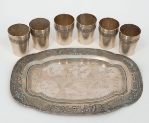 A set of six Vietnamese&nbsp;silver cordial cups and tray with Indo-Chinese engraving and repouss&eacute; decoration. Marked Vietnam, 90, Quyettien, Assey 800 (5 pointed star with hammer and sickle), 20th century, (7 items), the tray 20cm wide, 286 grams total.