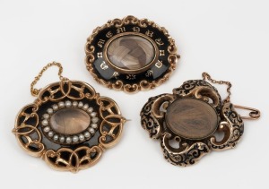 Three antique mourning brooches with black enamel decoration, 19th century, the largest 5cm wide, 52 grams including the mourning windows.