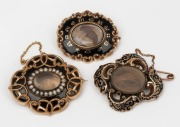 Three antique mourning brooches with black enamel decoration, 19th century, the largest 5cm wide, 52 grams including the mourning windows.