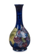 MOORCROFT&nbsp;"Clematis" English pottery vase on blue ground, circular paper label to base, 21.5cm high