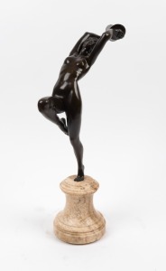 An Art Deco bronze statue of a dancing female nude with cymbals, mounted on a turned brown onyx plinth, 39cm high
