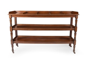 A pair of antique English walnut newspaper-magazine dumb&nbsp;waiters. Each with three fixed tiers plus gallery backs and the top with dividers. Turned front supports terminating in porcelain castors, circa 1890, each 102cm high, 169cm wide, 49cm deep.