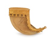 An antique Indian 22ct gold mounted tiger claw brooch with engraved decoration and ownership monogram "J.R.M.", 19th century, ​​​​​​​4cm wide overall.