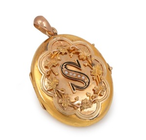 An antique yellow gold locket adorned with applied leaves and decorated with seed pearls and enamel, 19th century, 5cm high overall including bow, 8.4 grams gold weight (not including glass).