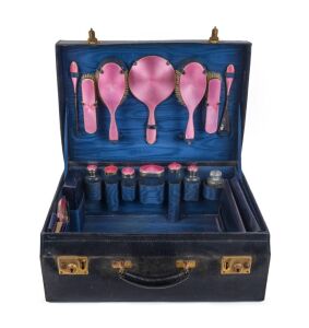 A vintage travel set, English sterling silver and pink enamel in original black leather fitted case, early 20th century, the case 51cm wide