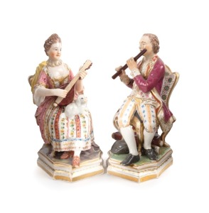 A pair of antique English Derby porcelain statues of seated musicians, 19th century, red factory mark to base, the larger 16cm high