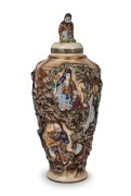 An antique Japanese lidded urn, intricately decorated with applied and raised scene of figures in landscape, Meiji Period, 19th/20th century, seal mark to base, 52cm high