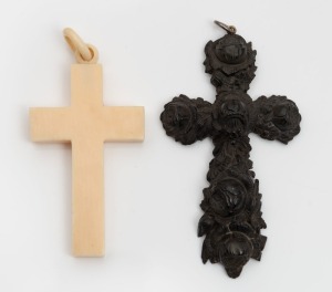 Two antique crucifix pendants, carved bog oak and carved ivory, 19th century, ​​​​​​​9cm and 8cm high overall.